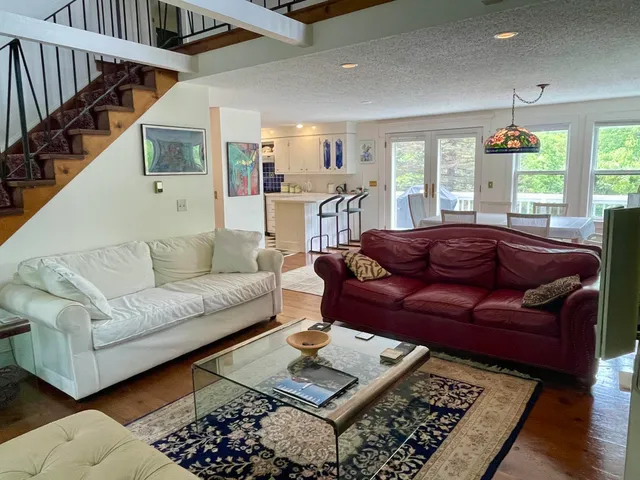 a living room with furniture rug and window