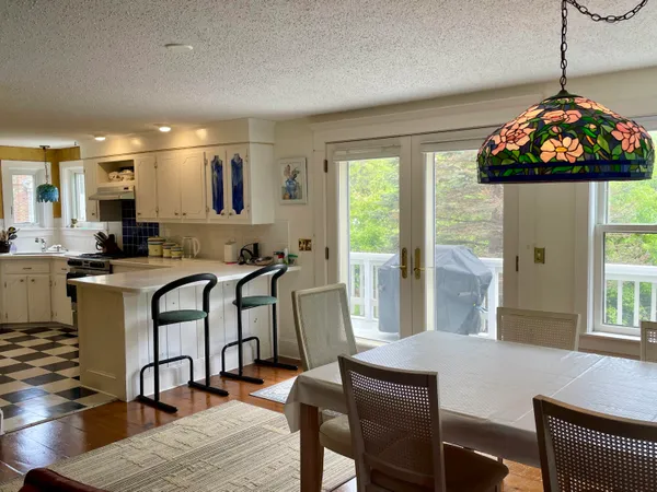 a view of a dining room with furniture and window