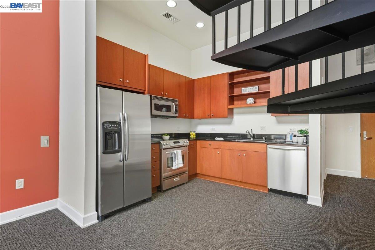 809 Clay Street Oakland, CA 94607 - Photo 10 of 39 a kitchen with stainless steel appliances granite countertop a stove and a refrigerator