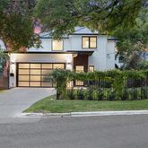 a front view of a house with a yard and a garage