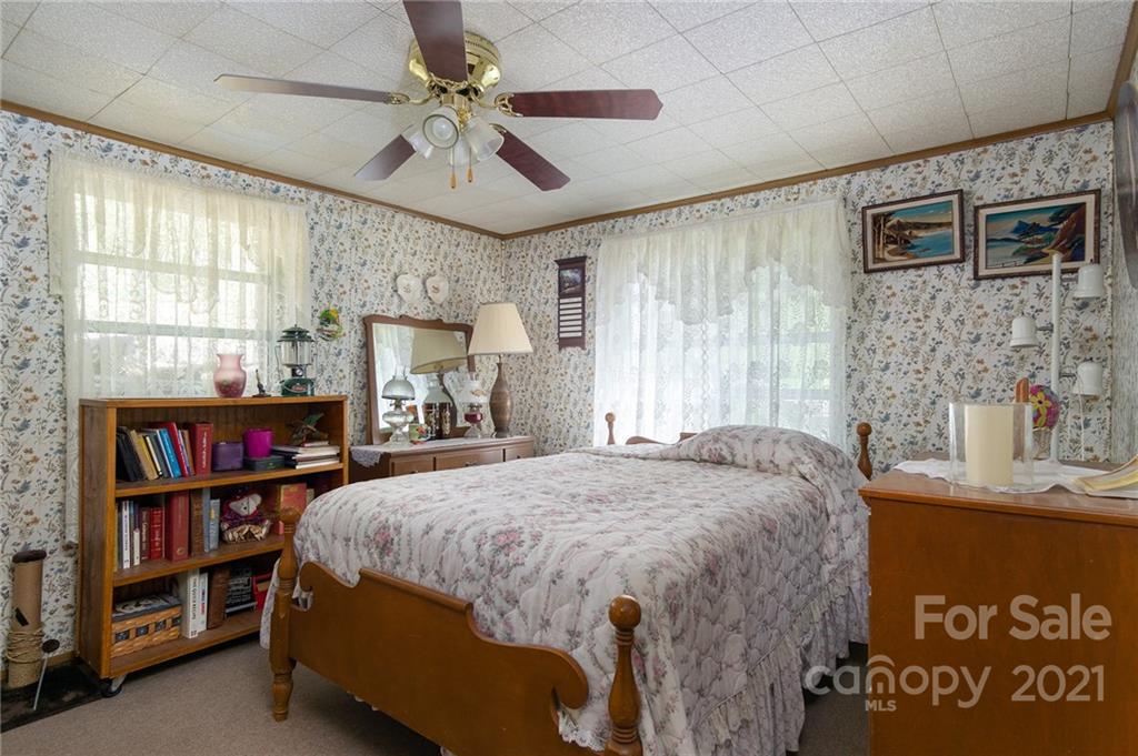 10200 Highway 23 Cheboygan, MI 49721 - Photo 12 of 14 a bedroom with a bed furniture and a book shelf