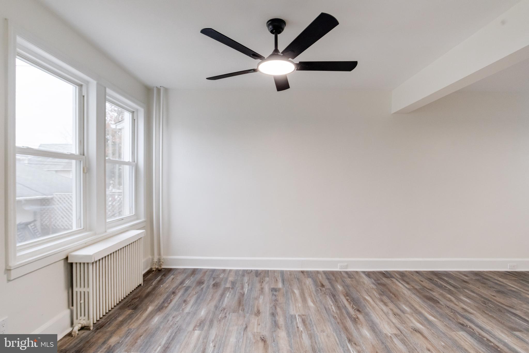 44 Shipway Baltimore, MD 21222 - Photo 11 of 53 an empty room with wooden floor and windows