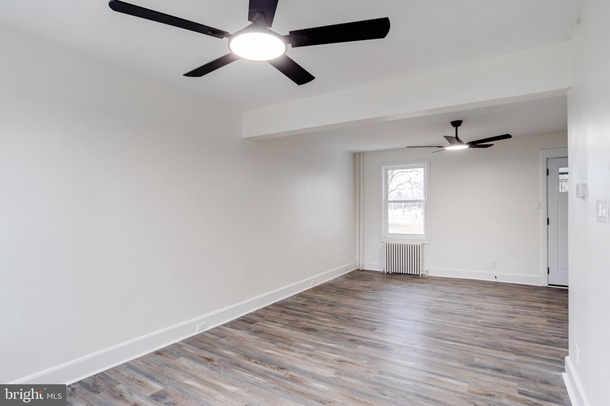44 Shipway Baltimore, MD 21222 - Photo 12 of 53 an empty room with wooden floor ceiling fan and windows