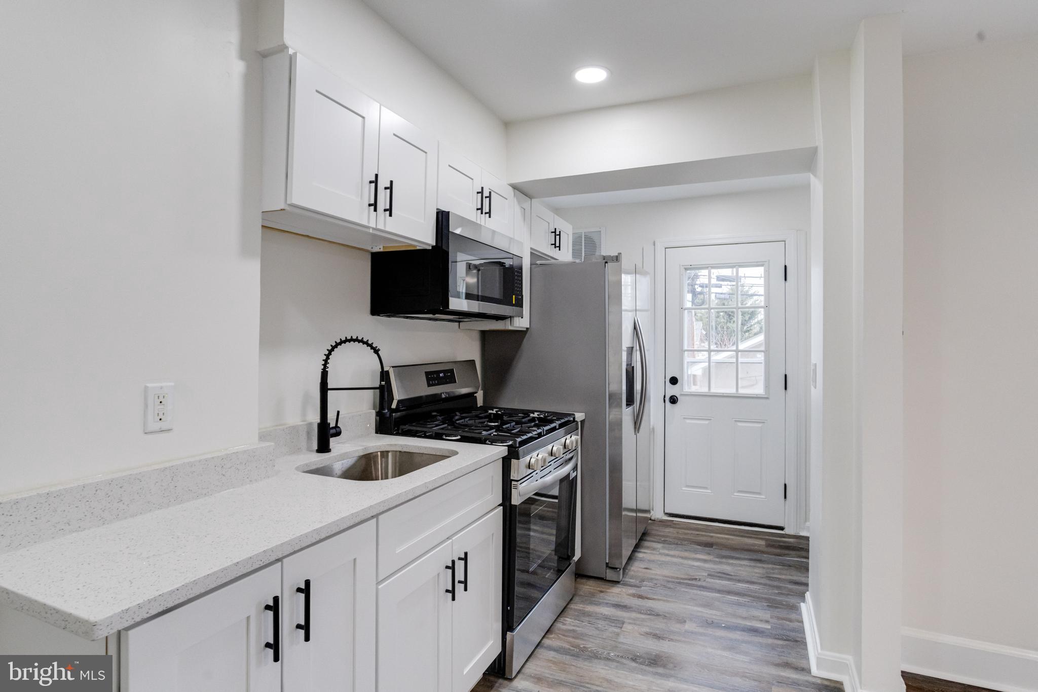 44 Shipway Baltimore, MD 21222 - Photo 15 of 53 a kitchen with stainless steel appliances a sink stove and cabinets