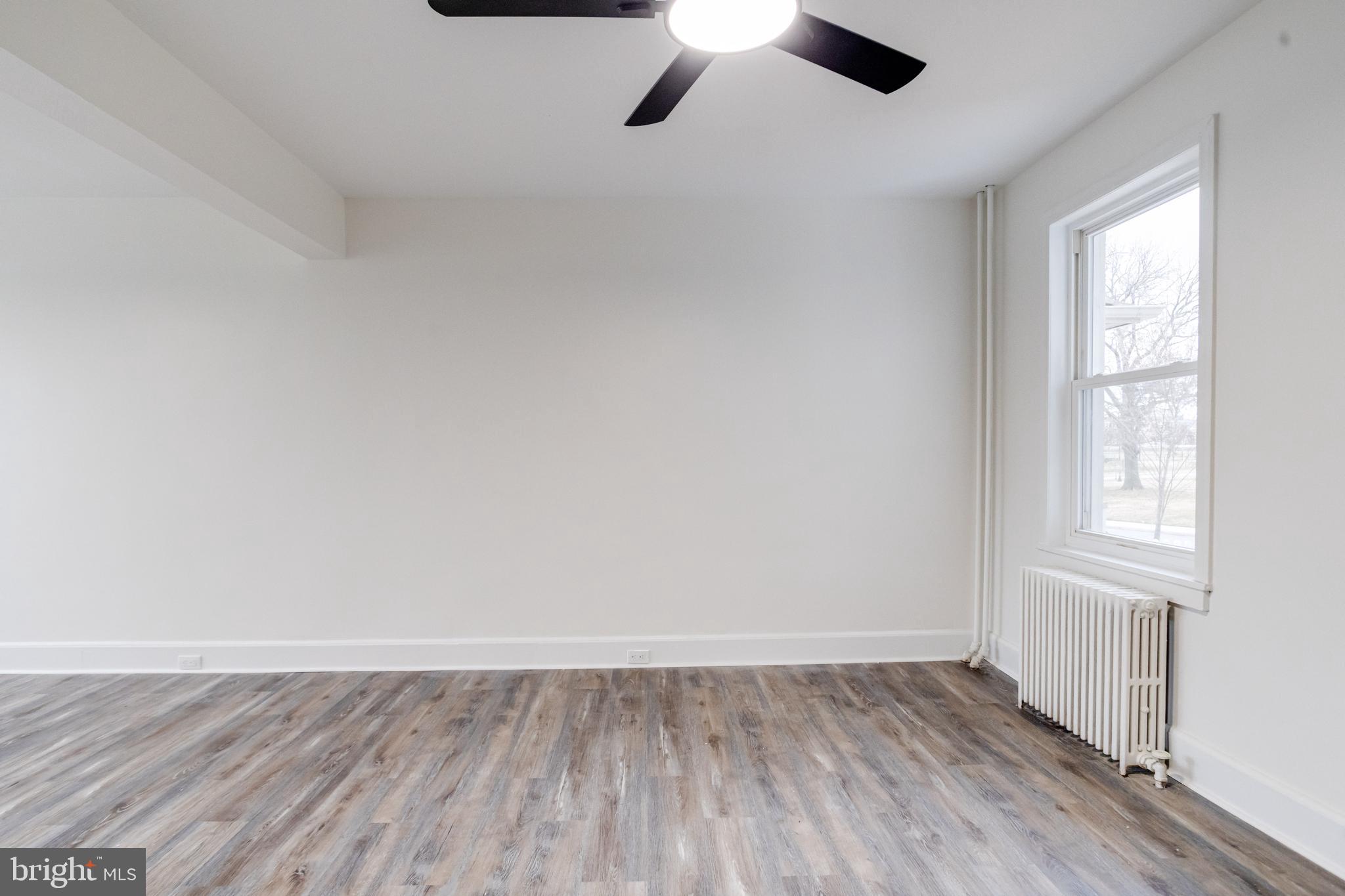 44 Shipway Baltimore, MD 21222 - Photo 5 of 53 an empty room with wooden floor and windows