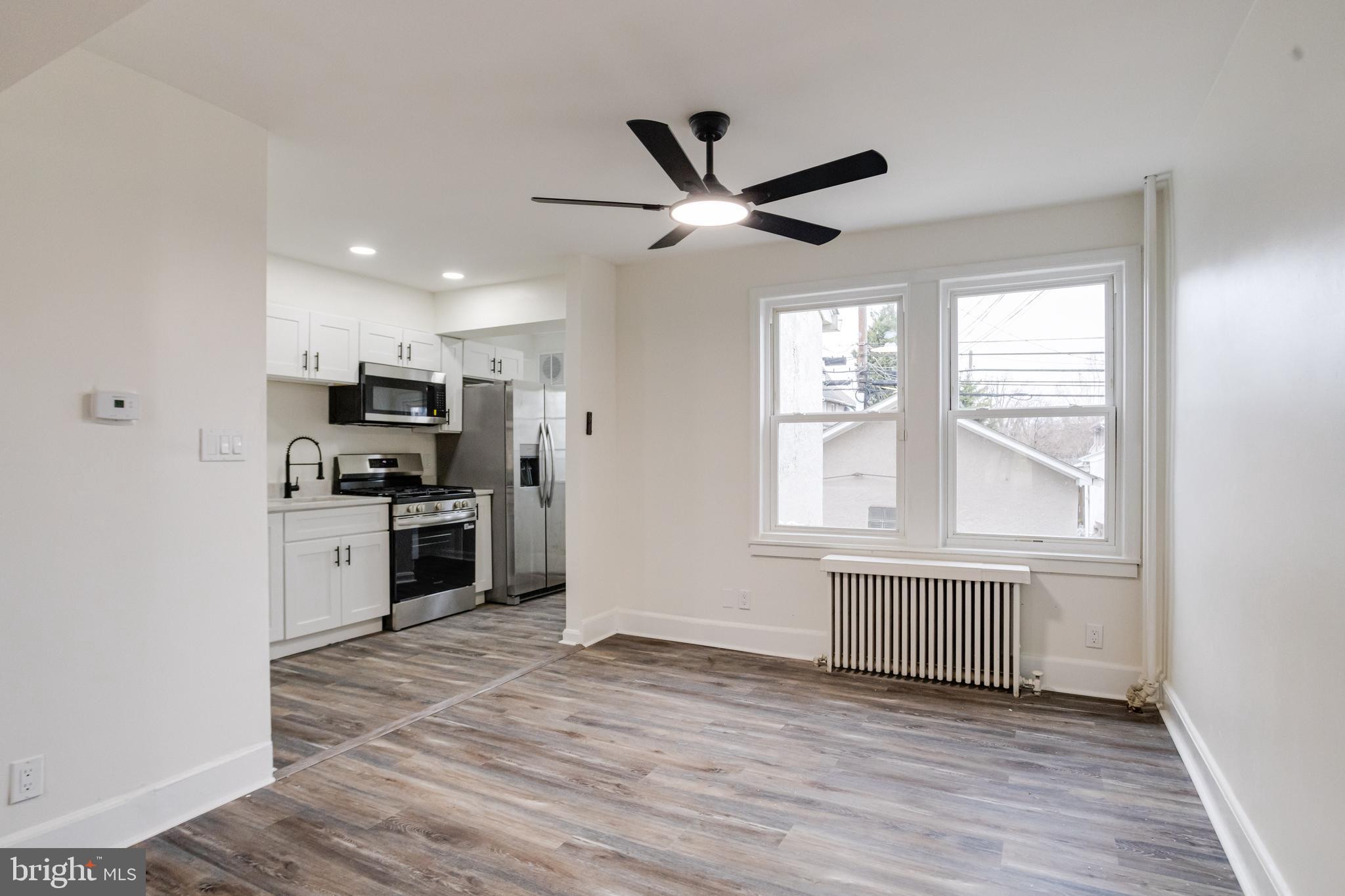44 Shipway Baltimore, MD 21222 - Photo 9 of 53 a view of a kitchen with a sink a ceiling fan and windows