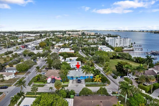 an aerial view of city and lake with trees all around