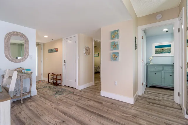 a view of livingroom with hardwood floor and a bathroom