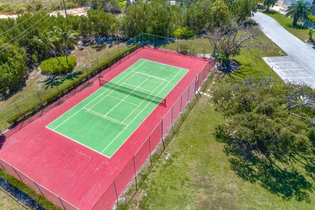 a view of a tennis ground with chairs