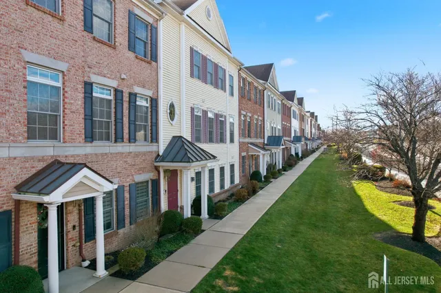 a front view of a residential apartment building with a yard