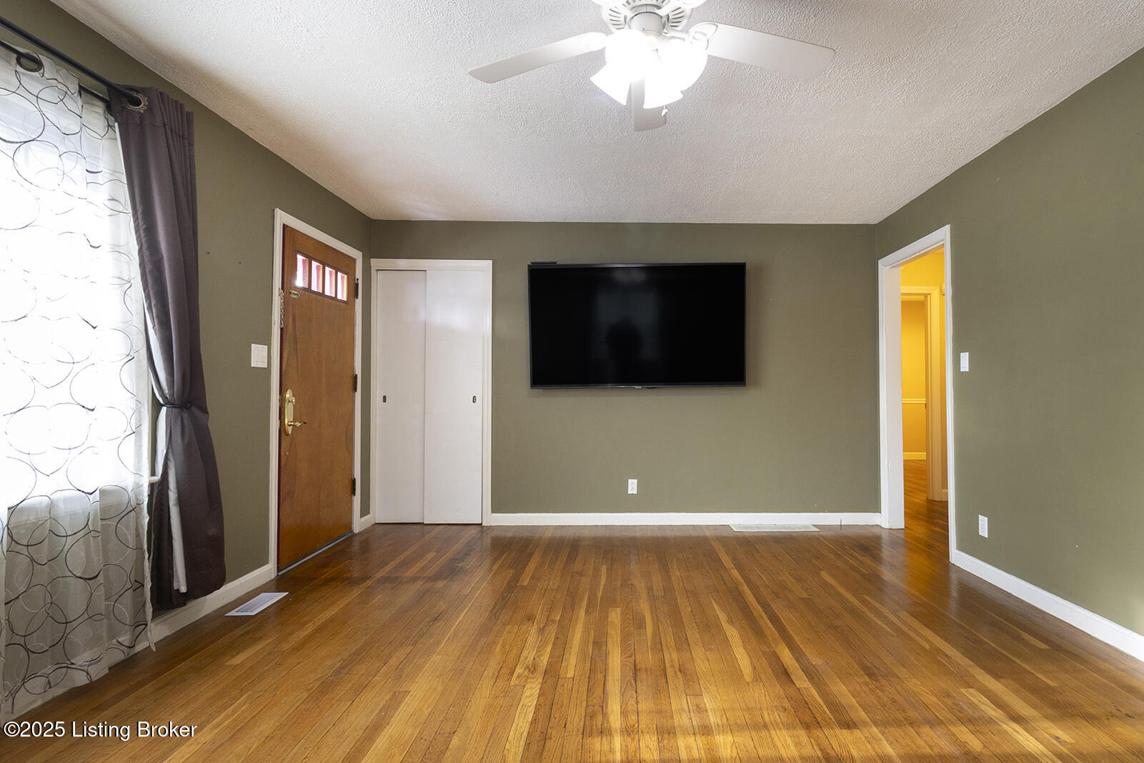 Spacious living room with hard wood floors