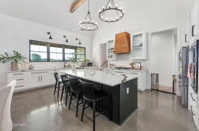 a large kitchen with a table and chairs in it
