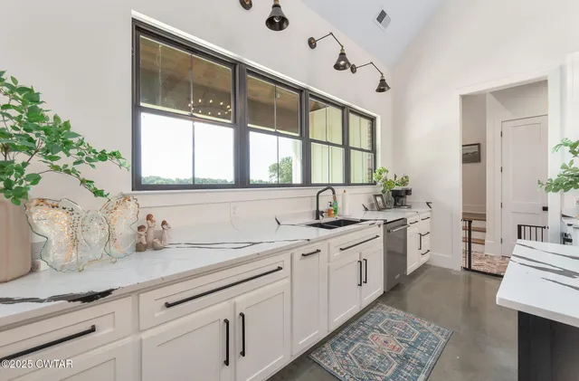 a kitchen with a sink cabinets and appliances