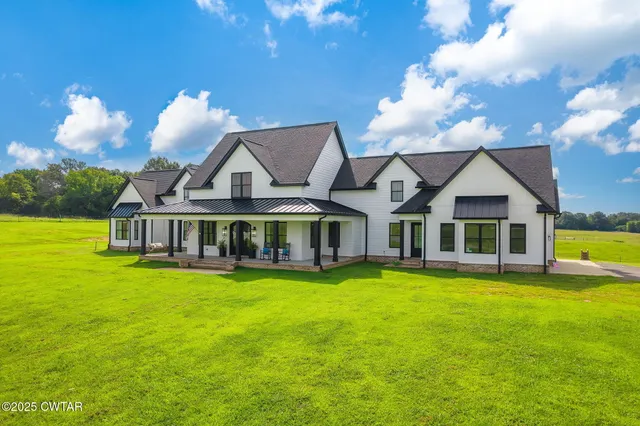 a view of a house with swimming pool and a yard