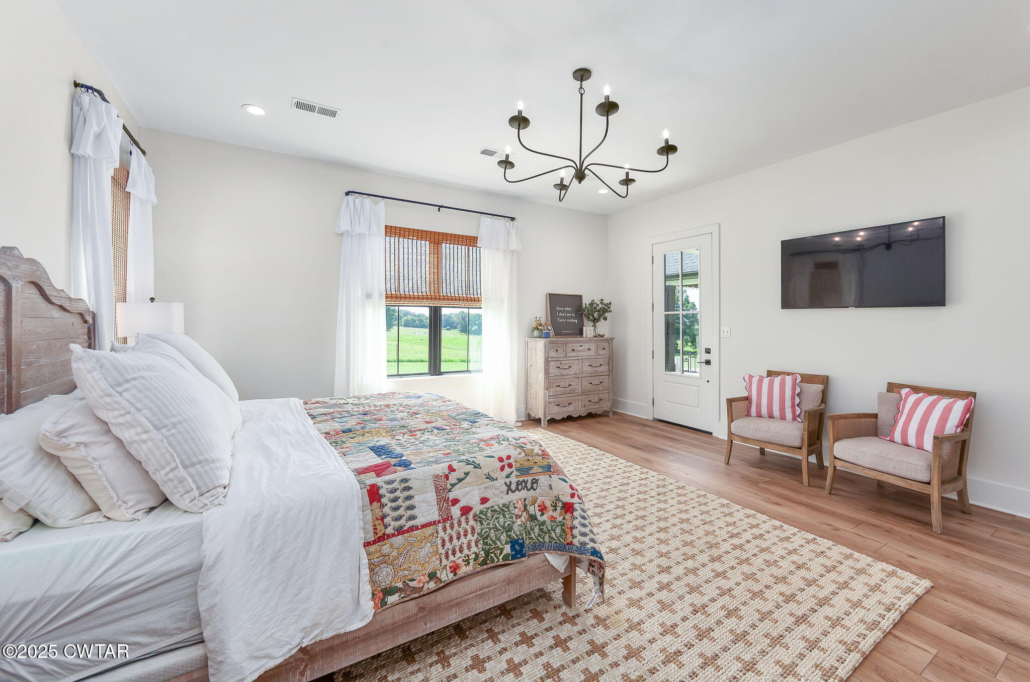 1644 Dr Conyers Road Friendship, TN 38034 - Photo 21 of 43 a bedroom with a bed a couch and a flat screen tv