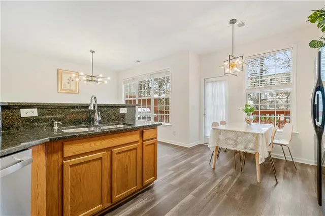 a very nice looking dining room with kitchen island hardwood floor and a view of living room