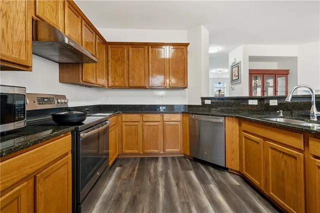 a kitchen with a sink stove and cabinets