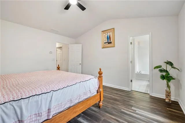 a bedroom with a bed and a potted plant