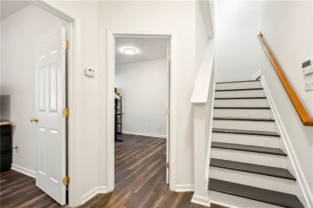 a view of a hallway with wooden floor and entryway