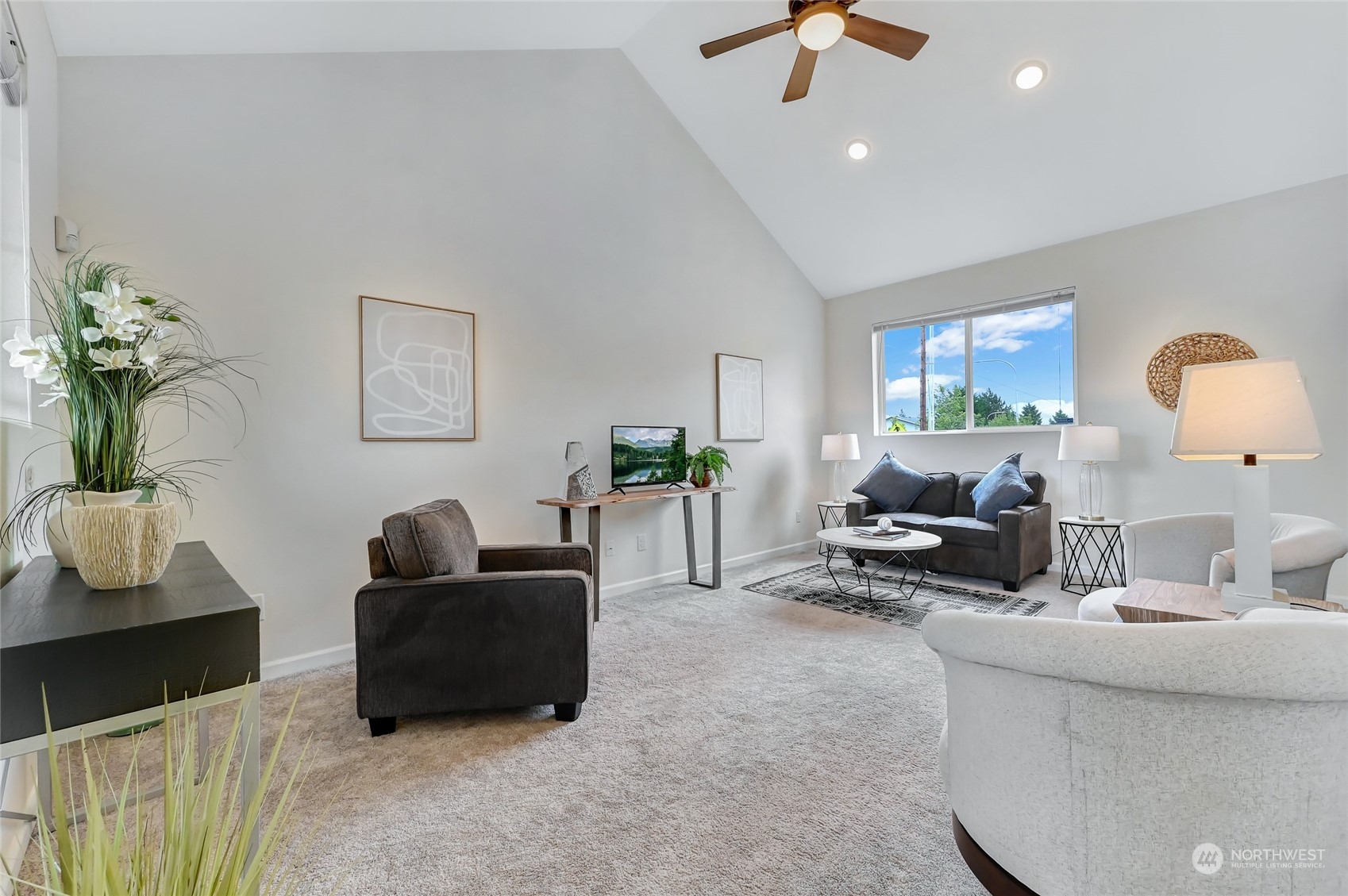 a living room with furniture and a potted plant