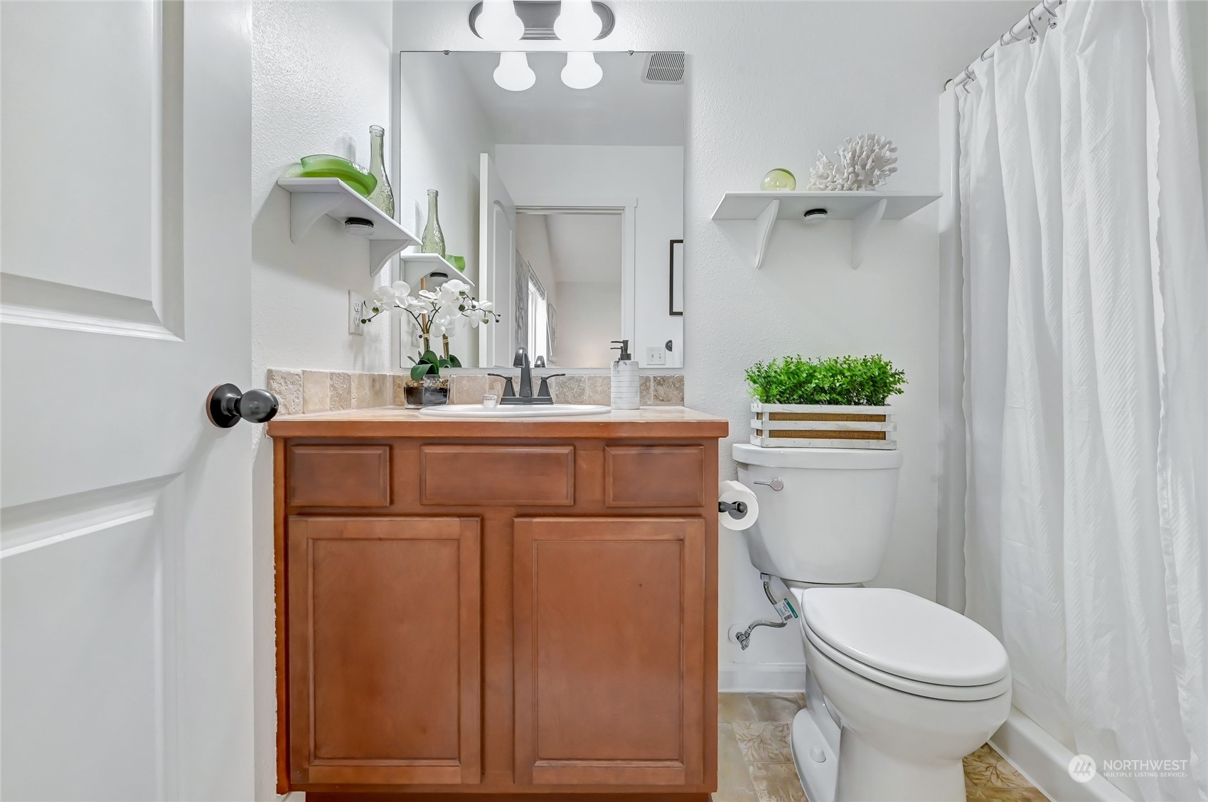 5027 Northeast 5th Place Renton, WA 98059 - Photo 17 of 29 a bathroom with a sink a toilet and shower