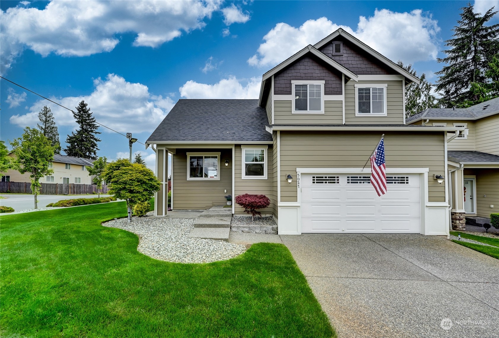 5027 Northeast 5th Place Renton, WA 98059 - Photo 28 of 29 a front view of a house with a garden and plants