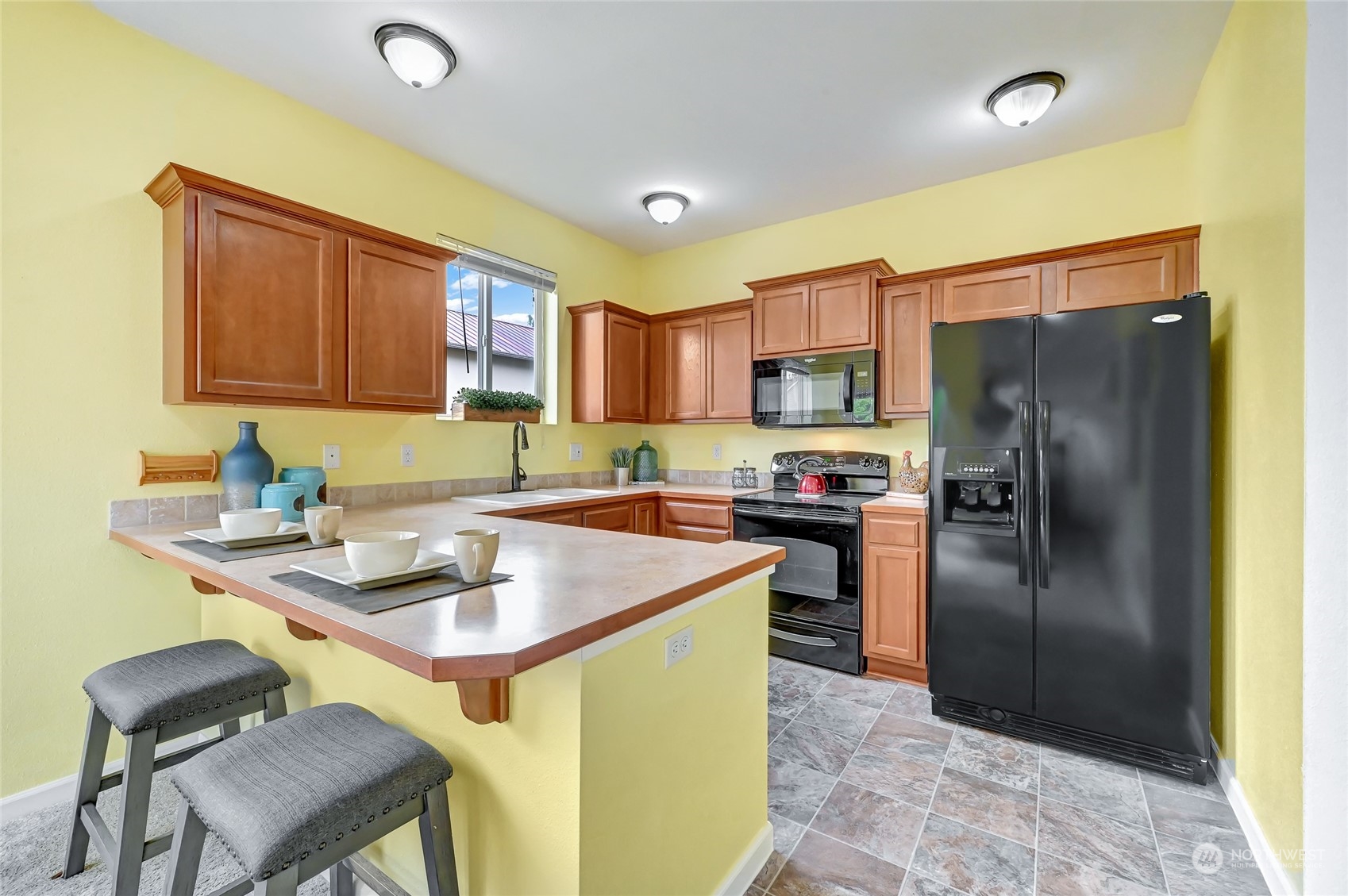 5027 Northeast 5th Place Renton, WA 98059 - Photo 8 of 29 a kitchen that has a sink cabinets and stainless steel appliances