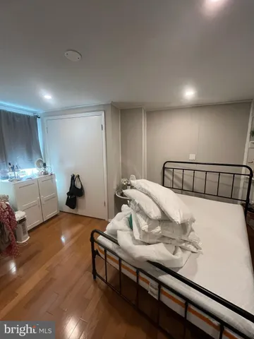 a bedroom with a bed and a night stand