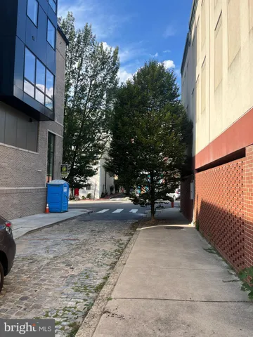 a view of a yard with wooden fence