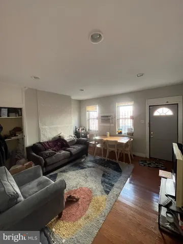 a living room with furniture a window and a table