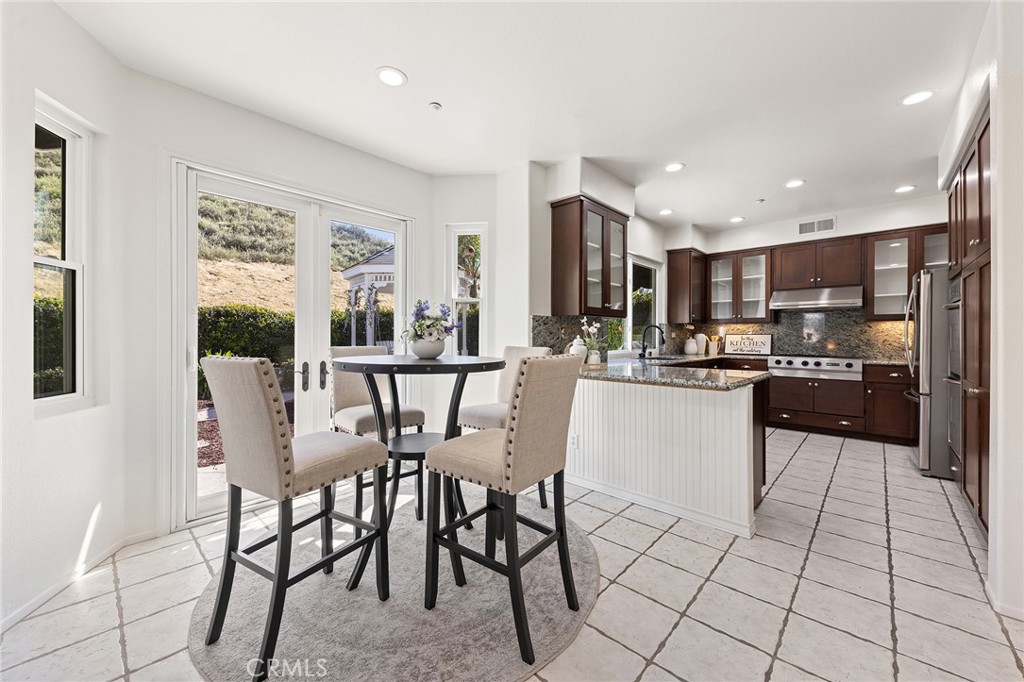 6133 Natalie Road Chino Hills, CA 91709 - Photo 23 of 62 a kitchen with stainless steel appliances kitchen island granite countertop a refrigerator and cabinets