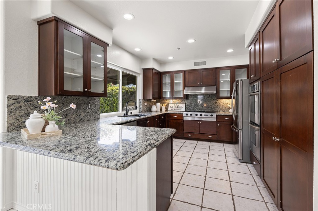6133 Natalie Road Chino Hills, CA 91709 - Photo 24 of 62 a kitchen with stainless steel appliances granite countertop a refrigerator a sink and a stove