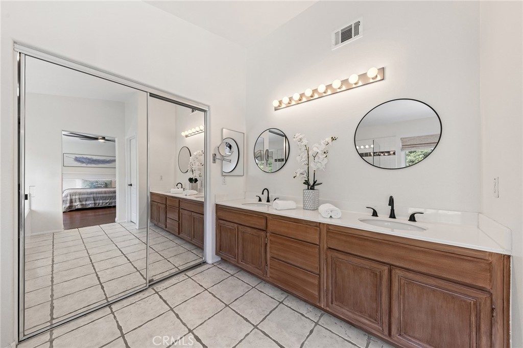 6133 Natalie Road Chino Hills, CA 91709 - Photo 37 of 62 a spacious bathroom with a double vanity sink and a mirror
