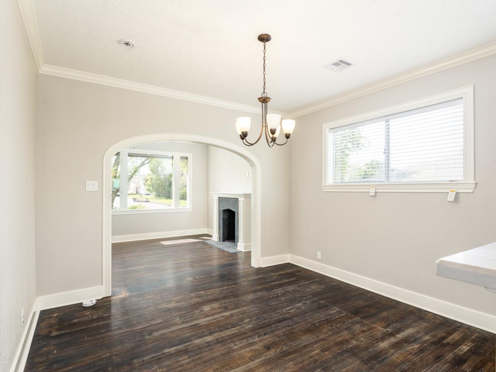 4528 Avenue R 1/2 Galveston, TX 77551 - Photo 12 of 22 a view of an empty room with wooden floor fireplace and a window