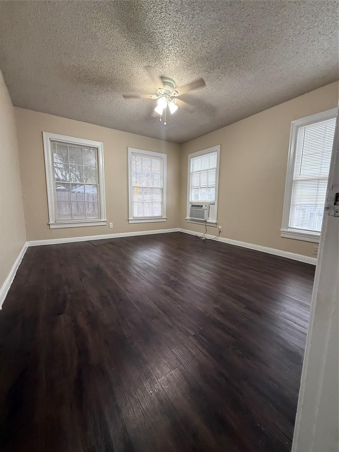 504 West St Johns Avenue, Unit A Austin, TX 78752 - Photo 11 of 17 a view of an empty room with wooden floor and a window