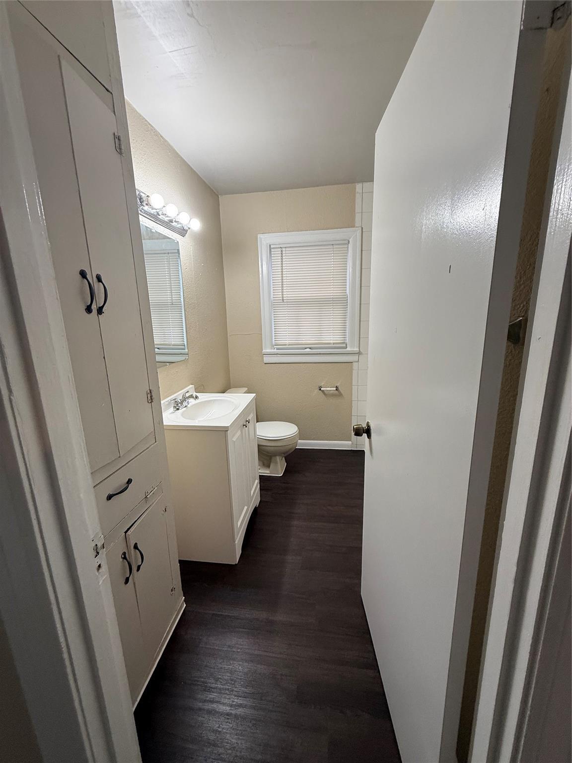504 West St Johns Avenue, Unit A Austin, TX 78752 - Photo 12 of 17 a bathroom with double vanity sink a mirror and a toilet