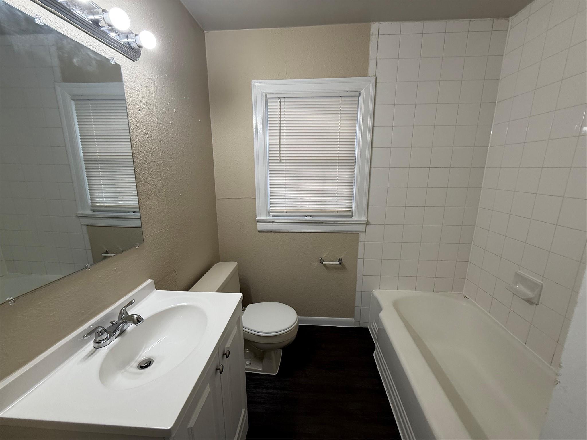 504 West St Johns Avenue, Unit A Austin, TX 78752 - Photo 13 of 17 a bathroom with a sink a toilet and shower