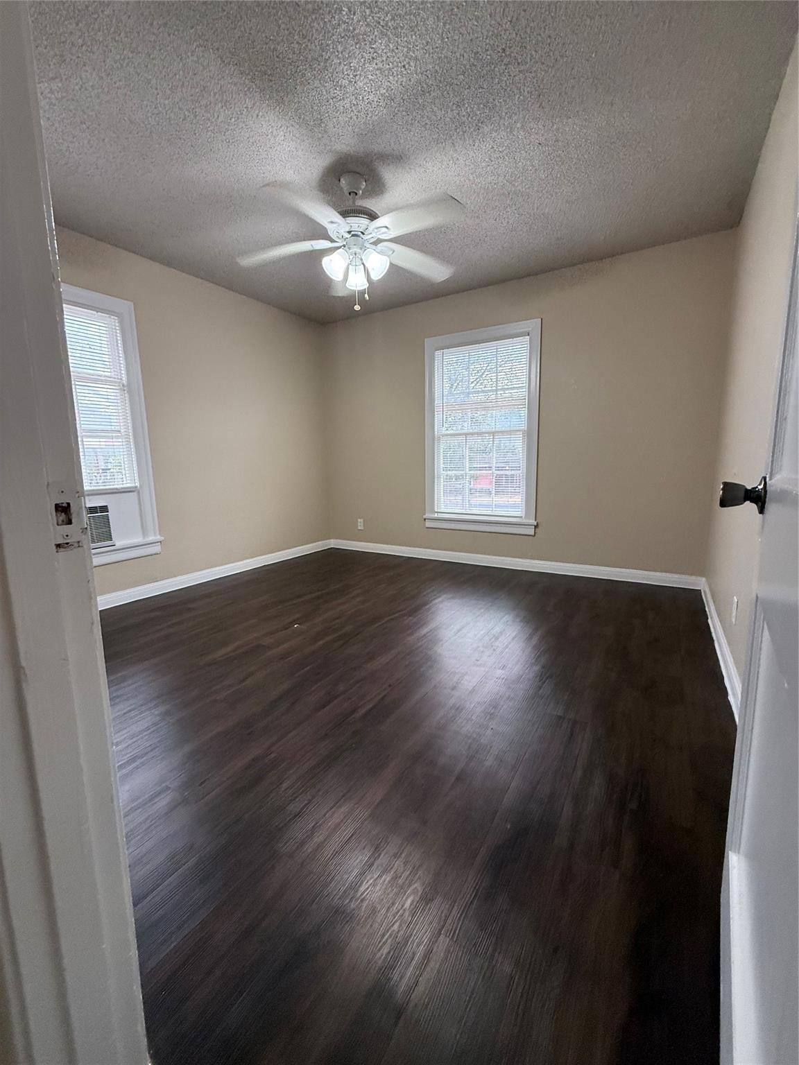 504 West St Johns Avenue, Unit A Austin, TX 78752 - Photo 10 of 17 a view of an empty room with wooden floor and a window