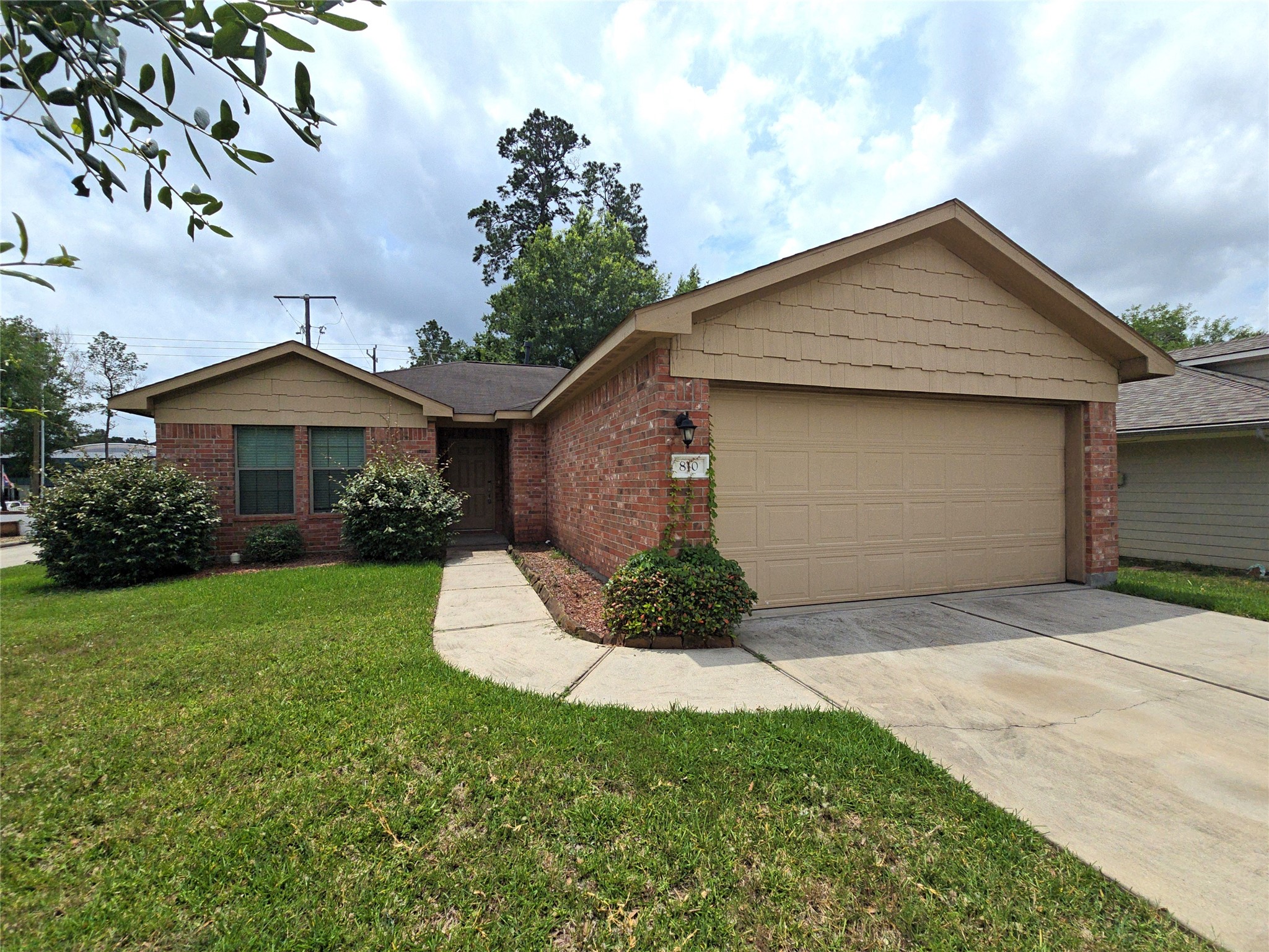 810 Lightningbug Lane Conroe, TX 77301 - Photo 1 of 27 a front view of a house with a garden and plants