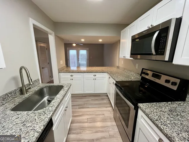 a kitchen with a stove sink and microwave