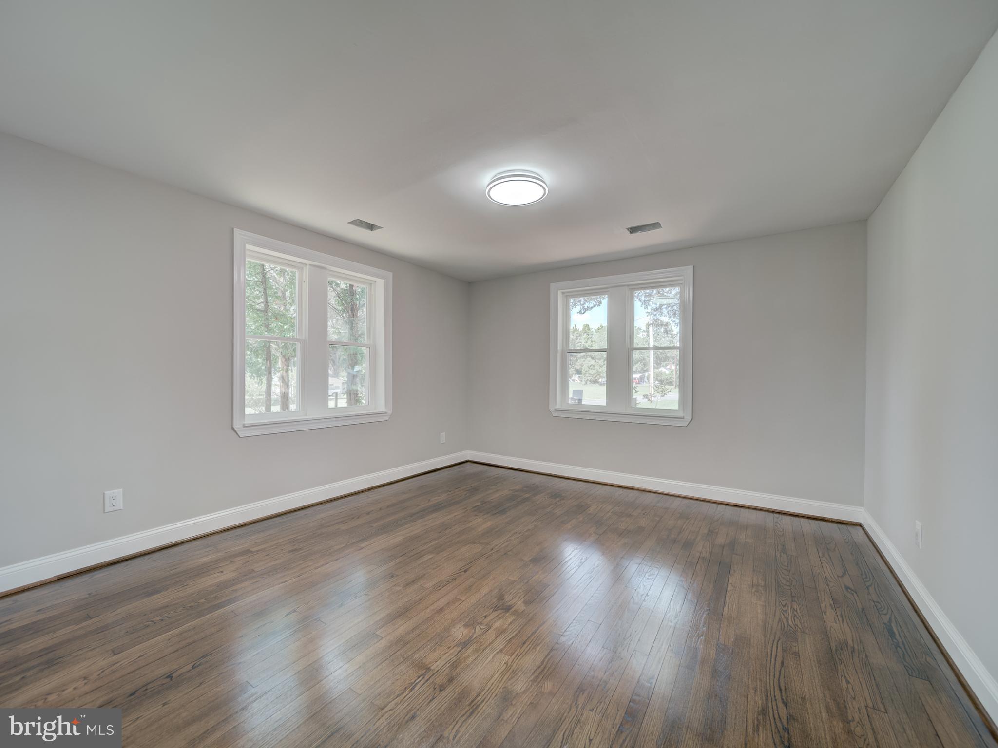 401 Bryan Point Road Accokeek, MD 20607 - Photo 12 of 48 an empty room with wooden floor and windows