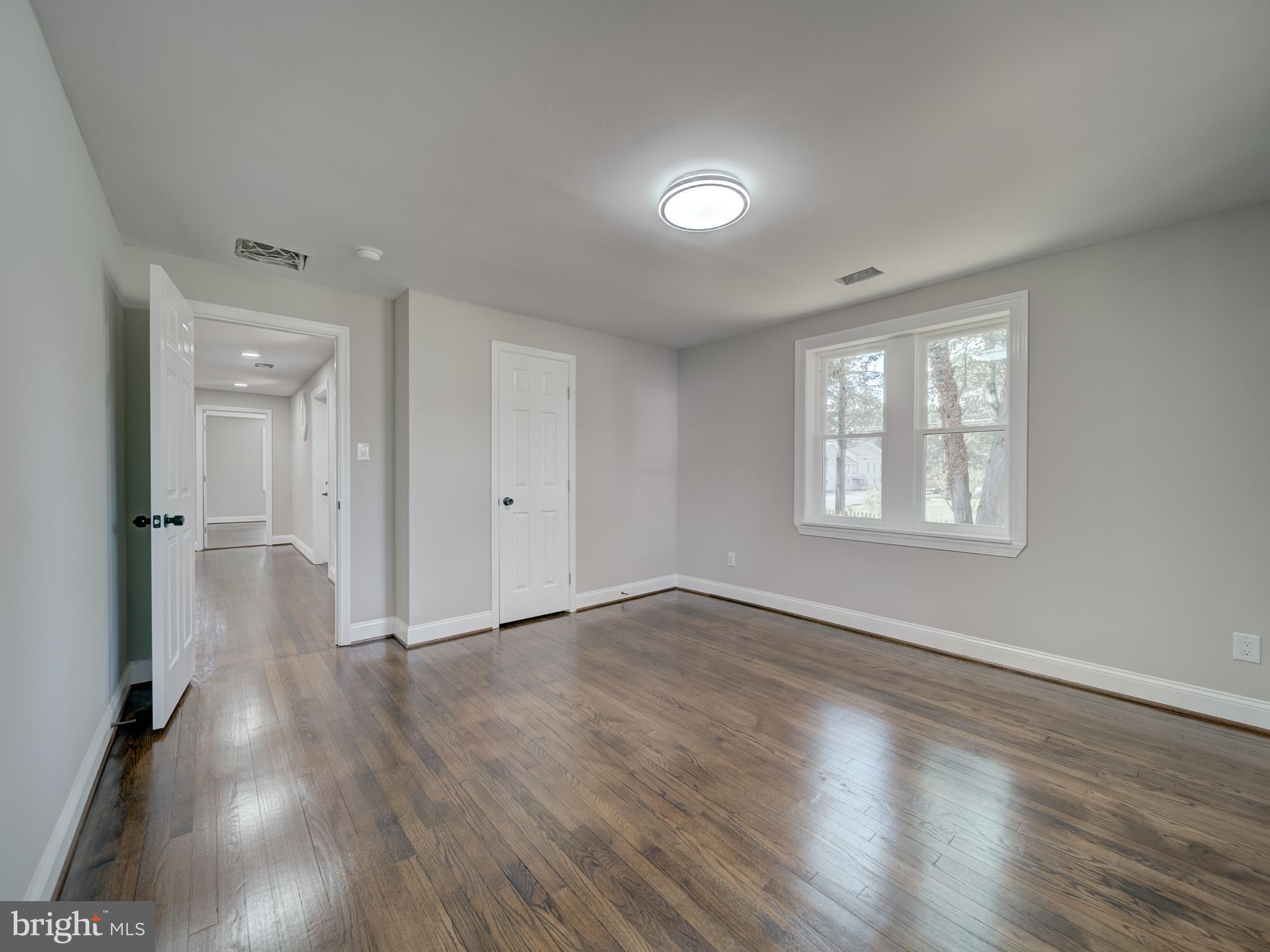 401 Bryan Point Road Accokeek, MD 20607 - Photo 15 of 48 a view of an empty room with wooden floor and a window