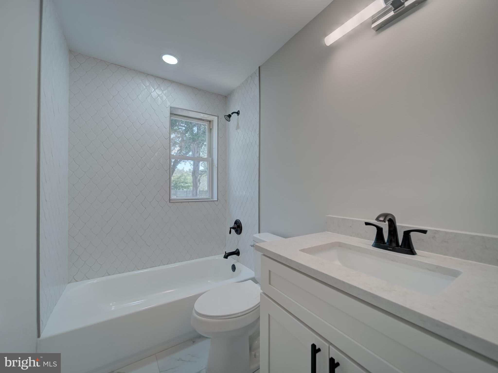 401 Bryan Point Road Accokeek, MD 20607 - Photo 20 of 48 a bathroom with a sink a toilet and bathtub