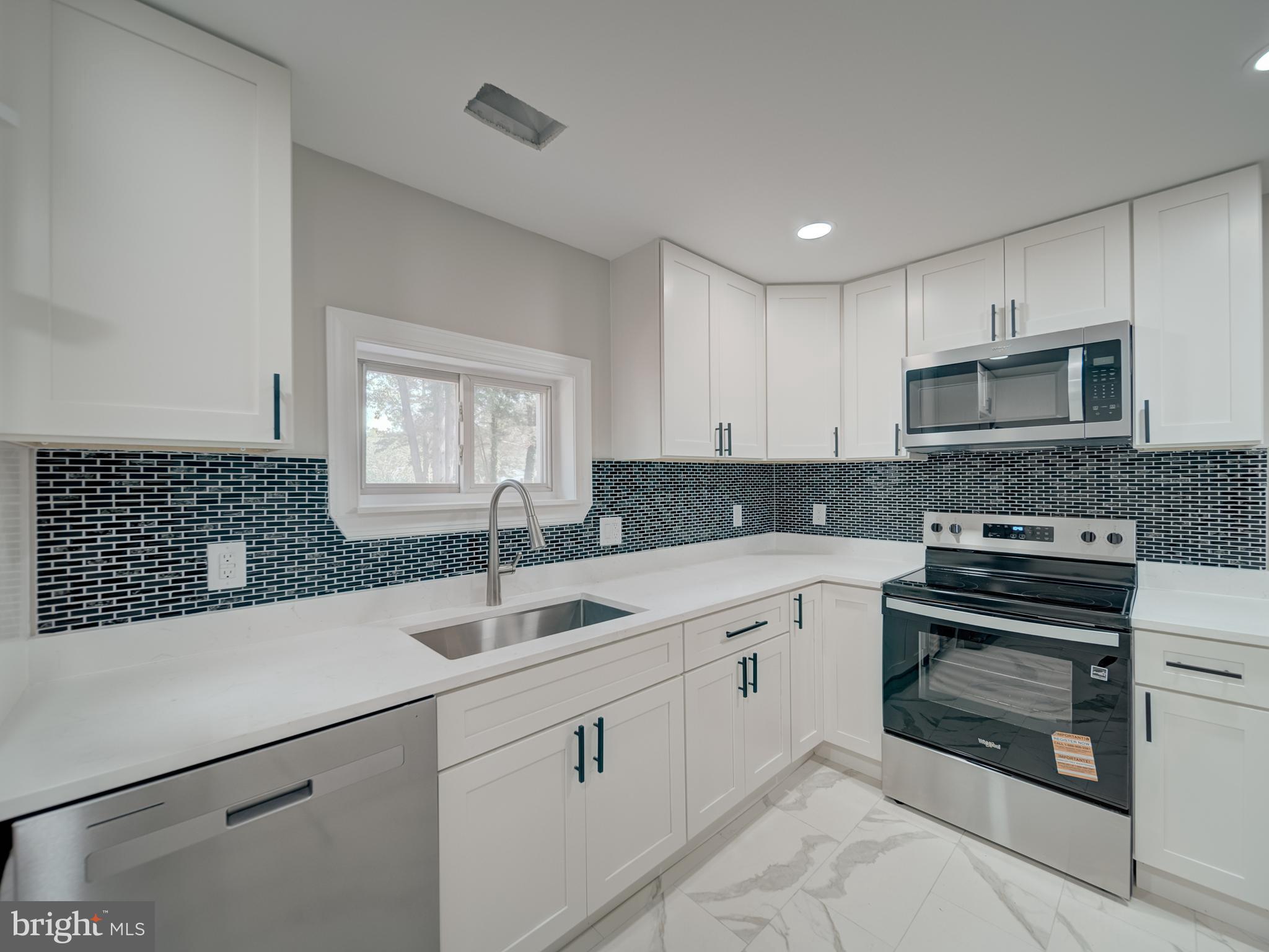 401 Bryan Point Road Accokeek, MD 20607 - Photo 23 of 48 a kitchen with a sink stove and microwave