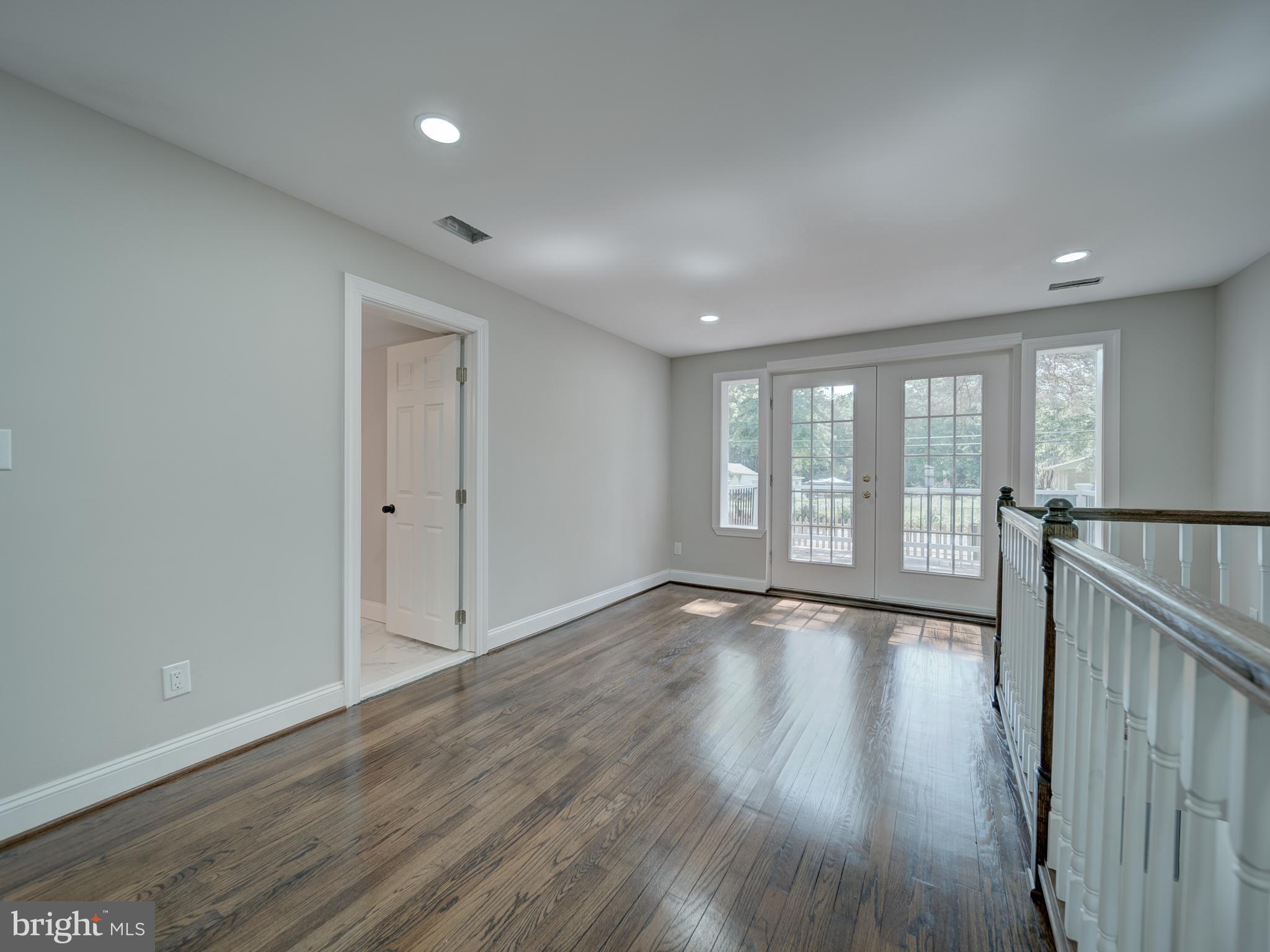 401 Bryan Point Road Accokeek, MD 20607 - Photo 27 of 48 a view of an empty room with wooden floor and a window