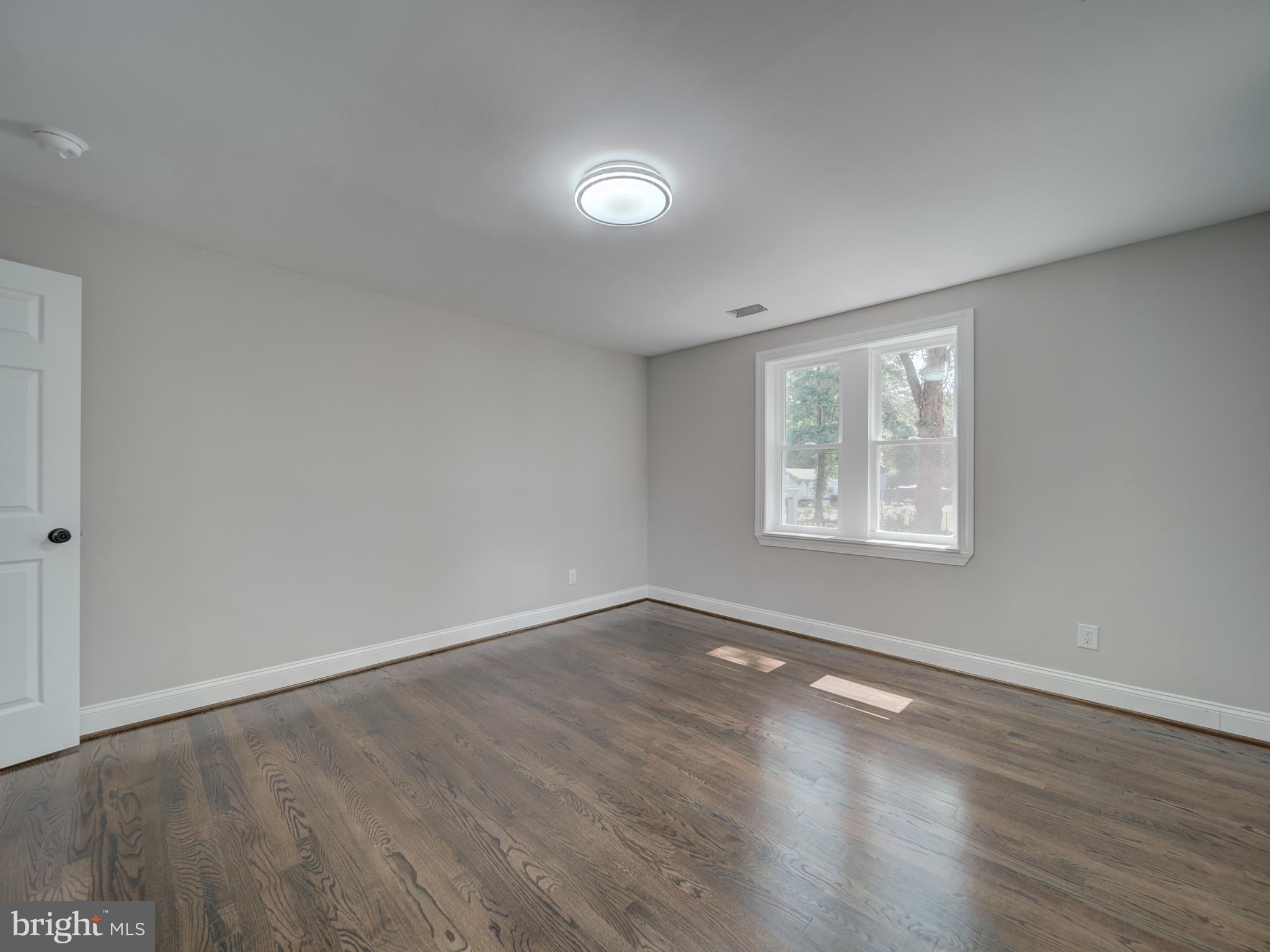 401 Bryan Point Road Accokeek, MD 20607 - Photo 30 of 48 an empty room with wooden floor and windows