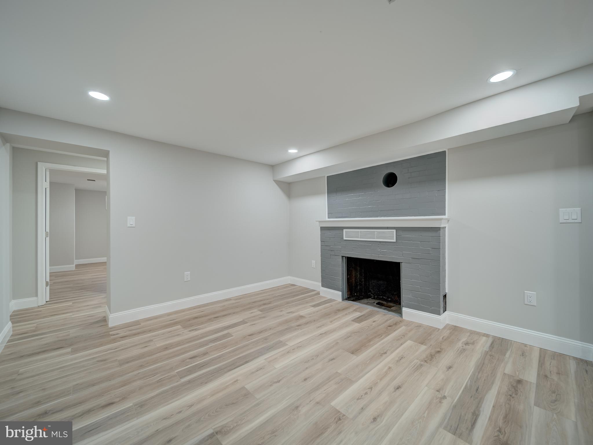 401 Bryan Point Road Accokeek, MD 20607 - Photo 35 of 48 an empty room with wooden floor and fireplace