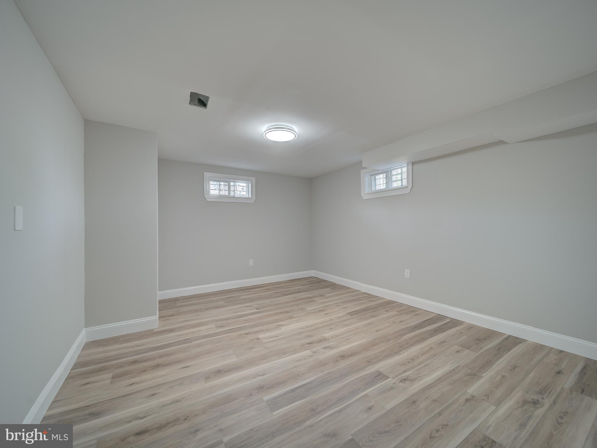 401 Bryan Point Road Accokeek, MD 20607 - Photo 38 of 48 an empty room with wooden floor and windows