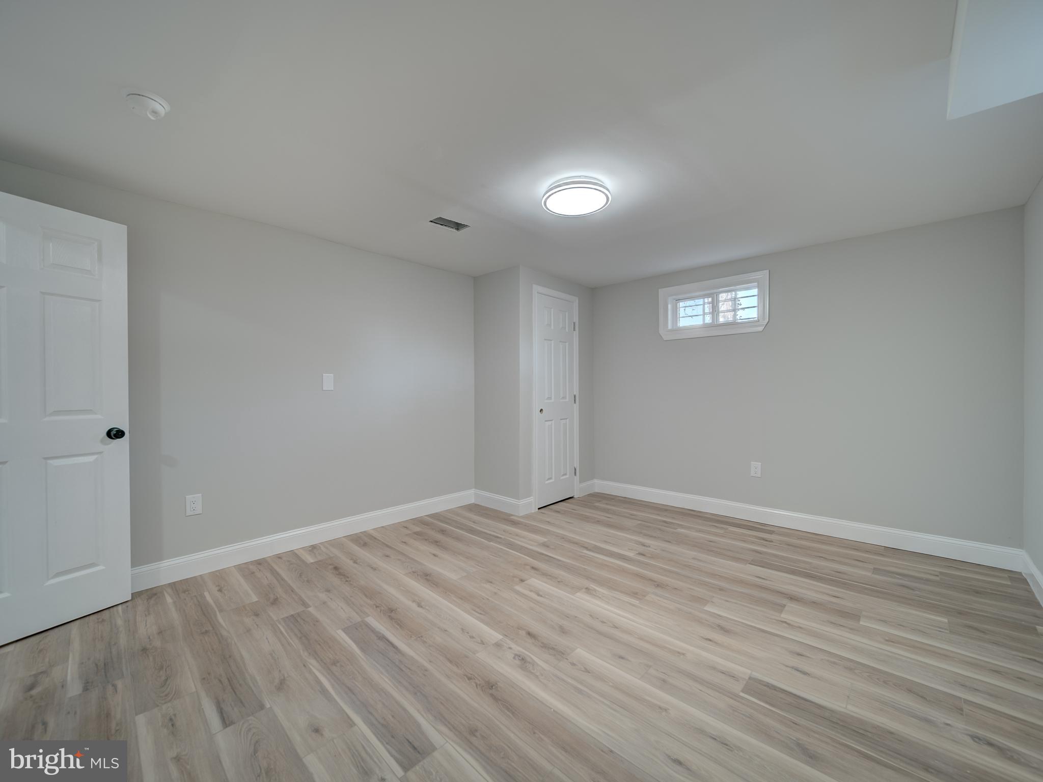 401 Bryan Point Road Accokeek, MD 20607 - Photo 39 of 48 an empty room with wooden floor and windows