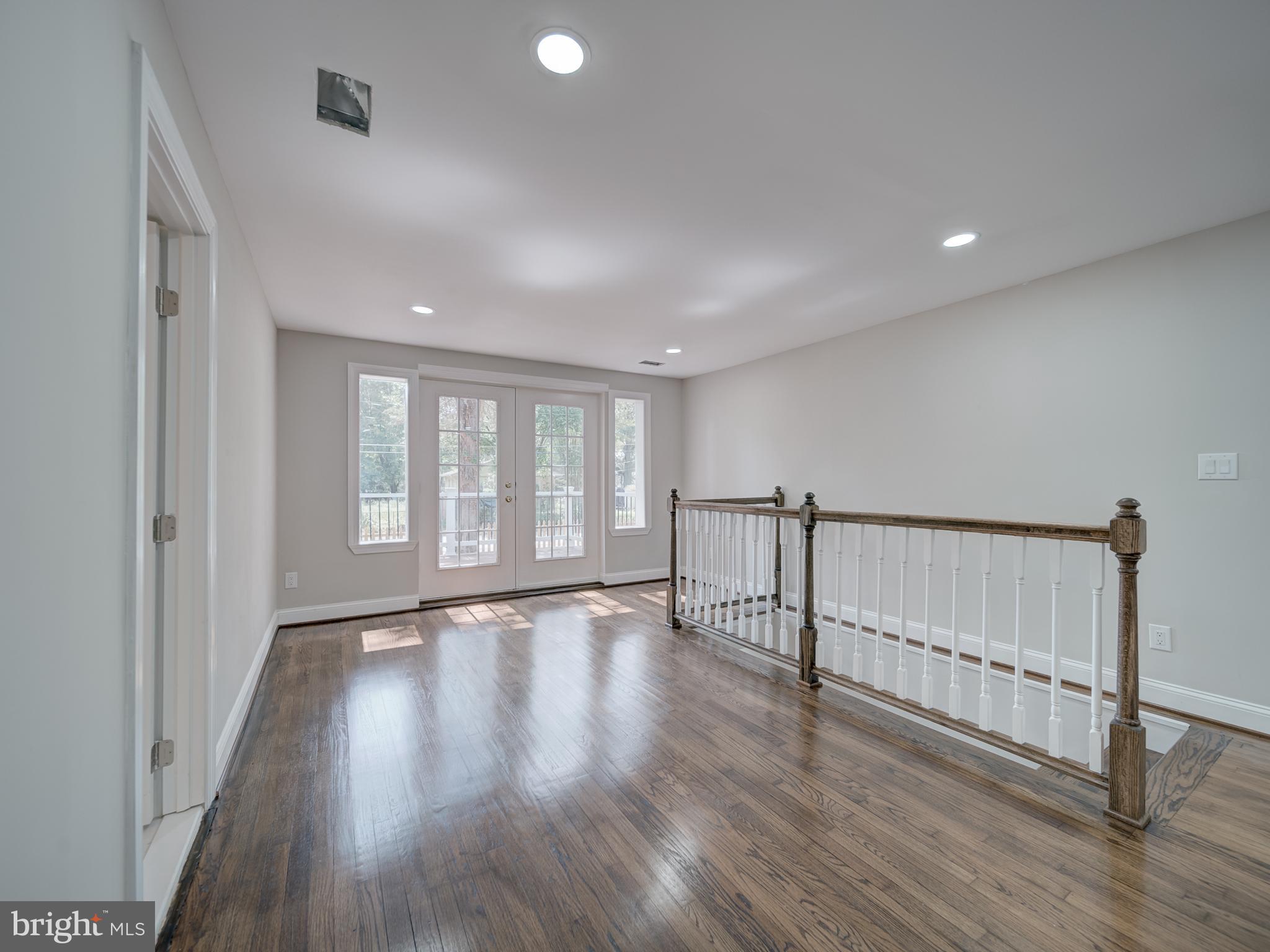 401 Bryan Point Road Accokeek, MD 20607 - Photo 10 of 48 a view of an empty room with wooden floor and a window